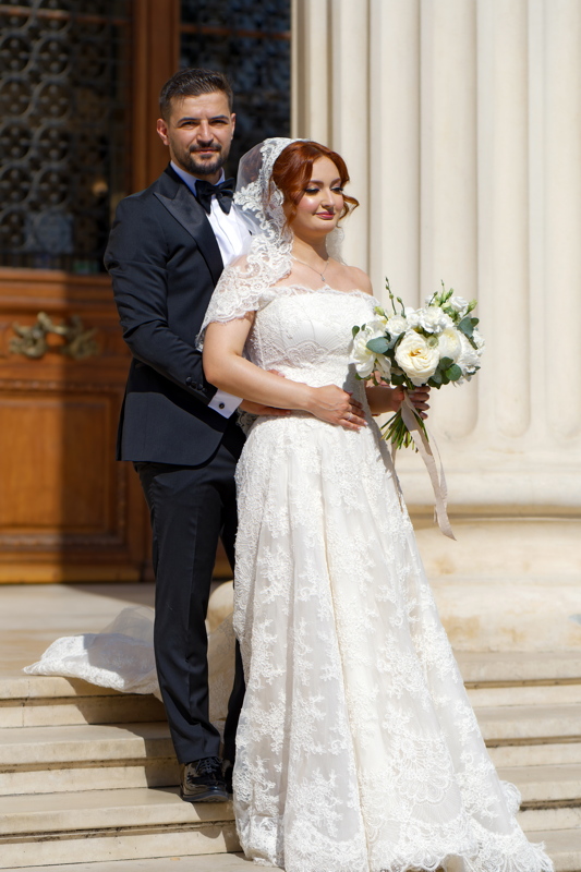 27 - Couple on their wedding day posed on stone steps